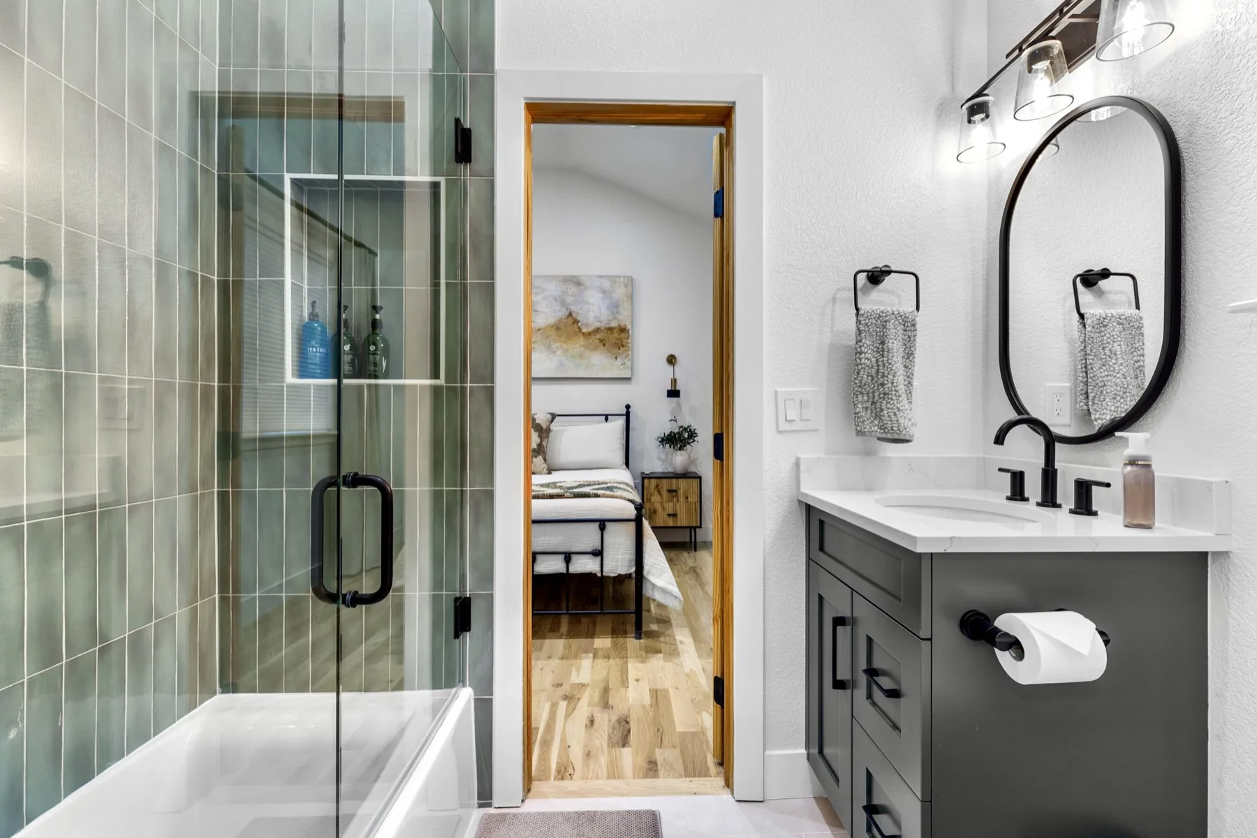 Bathroom renovation with green tile shower and custom vanity